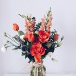 red flower arrangement on white table