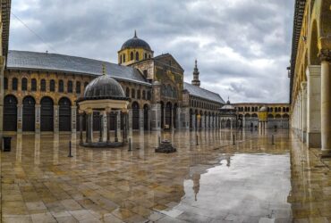 people walking near brown and gray concrete building during daytime