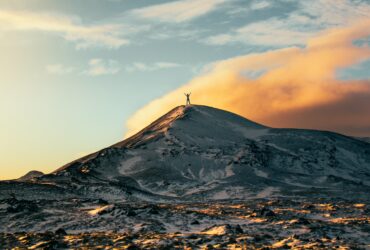 person standing on top of snow capped mountain during daytime