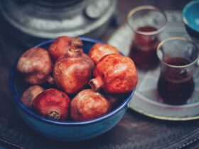 red fruits in blue ceramic bowl