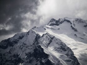 snow covered mountain under cloudy sky during daytime
