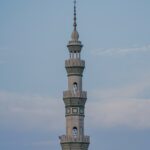 white concrete tower under white clouds during daytime