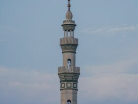 white concrete tower under white clouds during daytime
