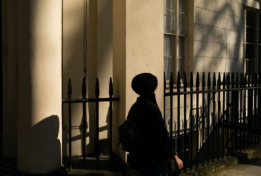 woman walking pass the building