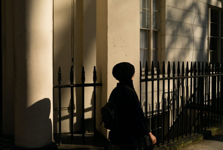 woman walking pass the building