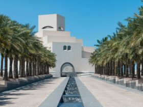 green palm trees near white concrete building during daytime