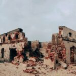brown concrete building under white clouds during daytime