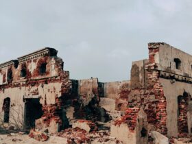 brown concrete building under white clouds during daytime