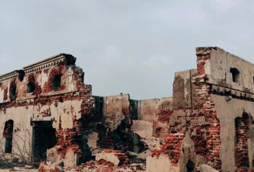 brown concrete building under white clouds during daytime