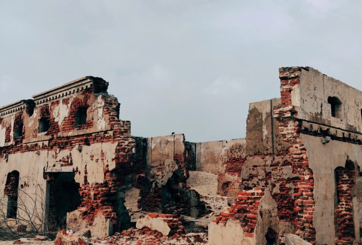 brown concrete building under white clouds during daytime
