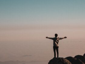 man standing beside cliff