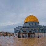 people walking on the street near green and brown dome building during daytime