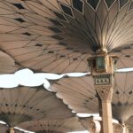 people under pillars with roofs
