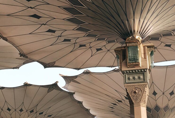 people under pillars with roofs