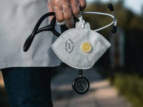 person in blue denim jeans with gray and black metal padlock