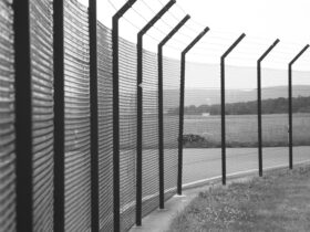 grayscale photo of metal fence