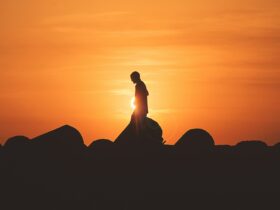 person standing on rock platform