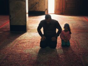 boy in black long sleeve shirt sitting beside girl in gray sweater