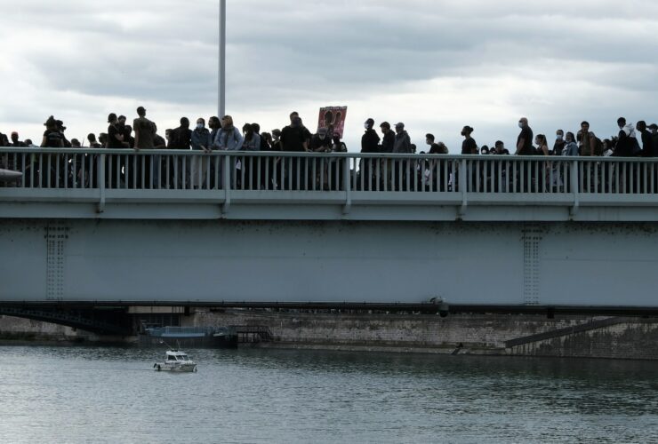 people walking on bridge over river during daytime
