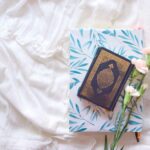 black and brown book on white and blue floral textile