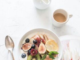 white ceramic plate beside gray steel spoon