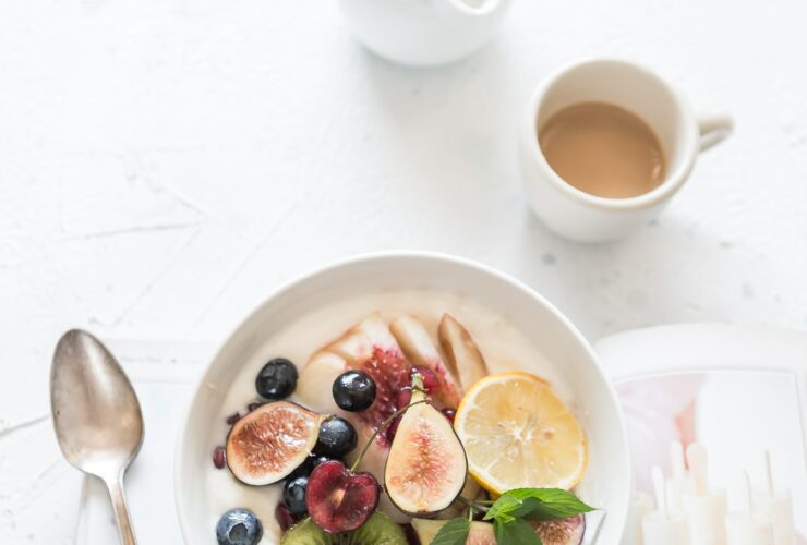 white ceramic plate beside gray steel spoon