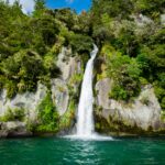 waterfalls surrounded with green-leafed trees during daytime