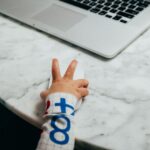person holding white and blue textile