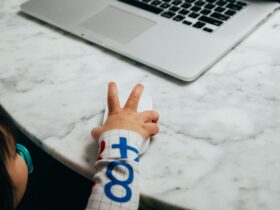 person holding white and blue textile