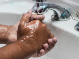 person washing hand on sink