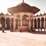 people walking on brown concrete building during daytime