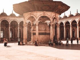 people walking on brown concrete building during daytime