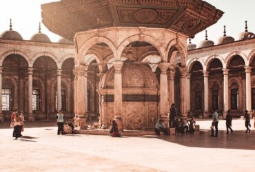people walking on brown concrete building during daytime