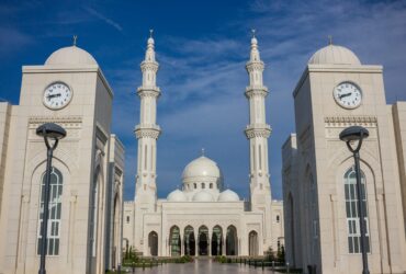 temple with two clock towers during day