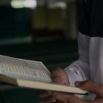 person in white long sleeve shirt reading book