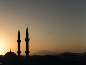 two mosque minarets under calm sky