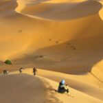 group of people standing on desert