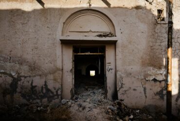brown wooden door on white concrete building