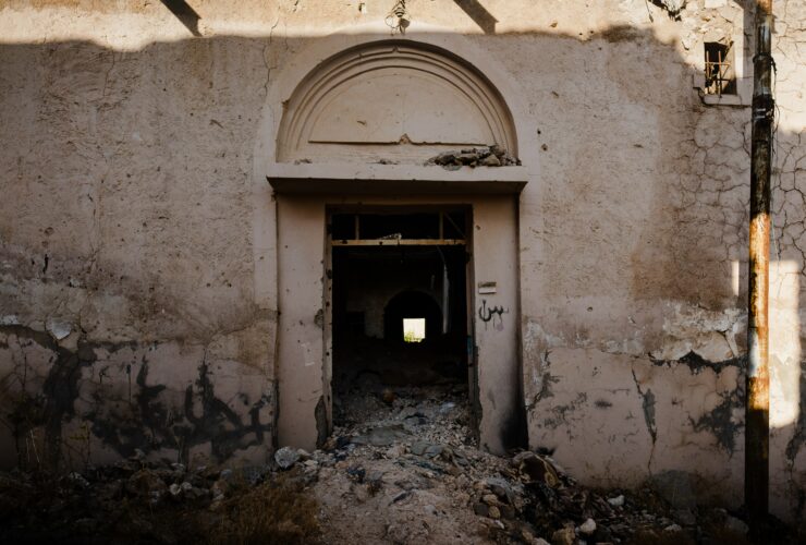 brown wooden door on white concrete building