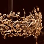 gold floral chandelier turned on in dark room