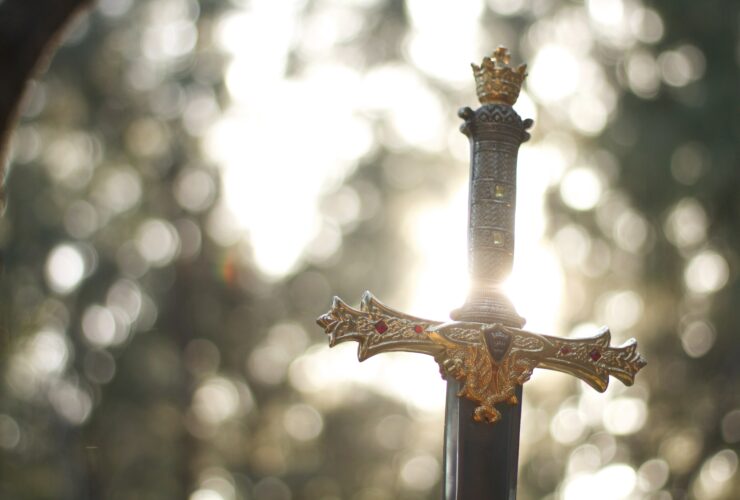 close-up photography of gold-colored and black sword