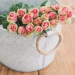 shallow focus photography of bouquet of pink flower in white bucket