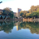 brown and white concrete building near body of water during daytime