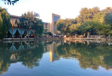 brown and white concrete building near body of water during daytime