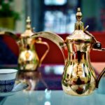 white and red floral ceramic teapot on table