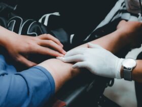 person in blue long sleeve shirt holding persons hand