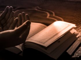 person reading book on brown textile