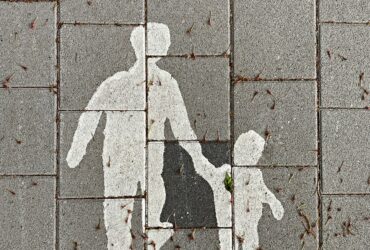 2 person walking on gray concrete pavement