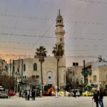 people walking on street near brown concrete building during daytime