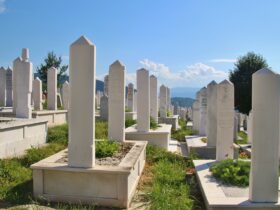 white concrete cross on green grass during daytime